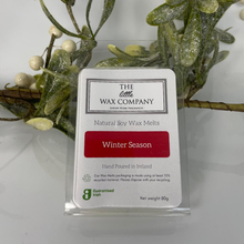 Pack of The Little Wax Company wax melts labeled 'Winter Season' with decorative greenery in the background.