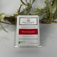Packaging of The Little Wax Company natural soy wax melts labeled 'Warm Cinnamon' with decorative mistletoe in the background.