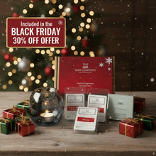 Wax melts and packaging with a Christmas tree in the background