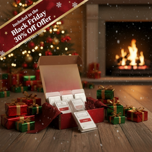 Open box of tea bags with Christmas decorations and a fireplace in the background