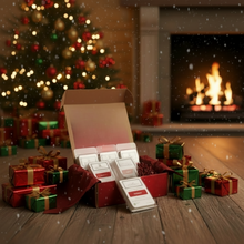 Open box of tea bags with Christmas decorations and a fireplace in the background