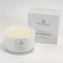 A large, white, round soy wax candle with three wicks, labeled 'Peony & Blush Suede', presented next to its packaging box which has 'The Little Wax Company' branding.