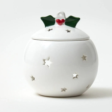 White ceramic jar with star patterns and a decorative lid on a white background