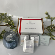 The Little Wax Company burner and wax melt gift set with decorative plants on a white surface.