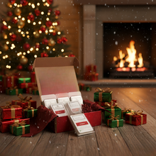 Open box of tea bags with Christmas decorations and a fireplace in the background