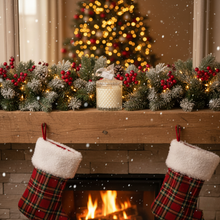Christmas stockings hanging by a fireplace with a decorated tree in the background